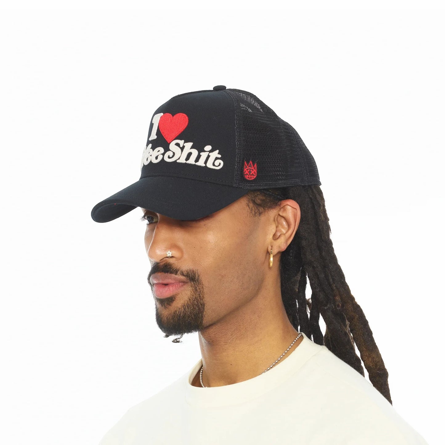 Ballers Clothing Shop black mesh back trucker hat with I LOVE FREE SHIT chainstitch embroidery on a model
