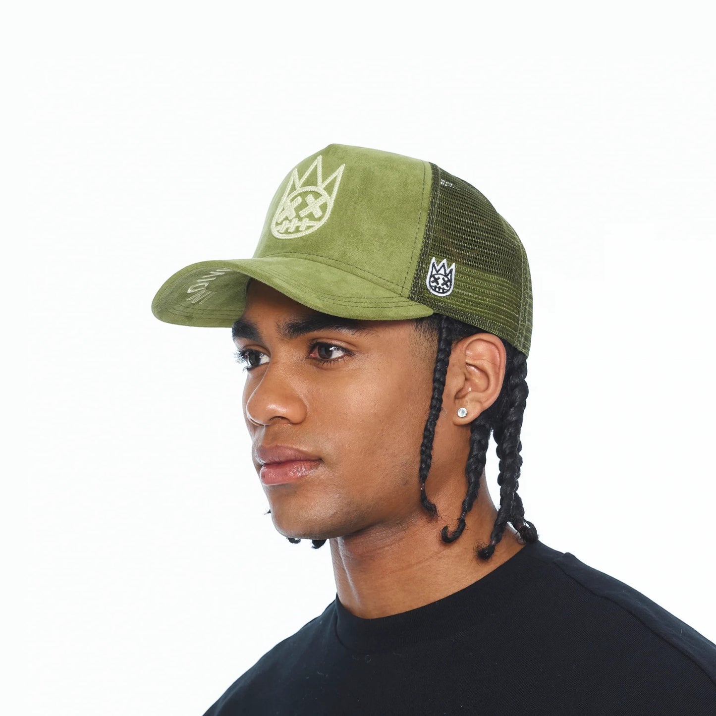 Ballers Clothing Shop sphagnum green suede trucker hat with mesh back and chain-stitch logo worn by a model.
