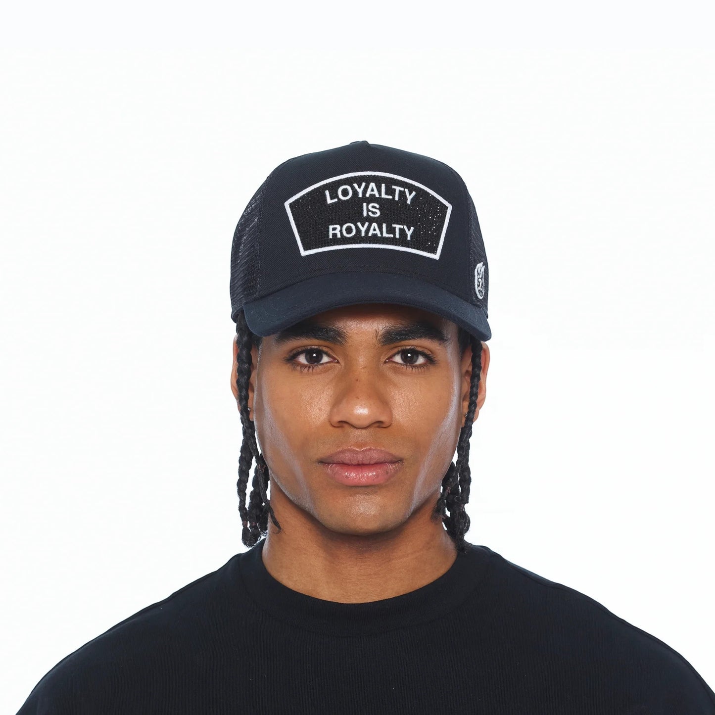 Ballers Clothing Shop black mesh trucker hat with Loyalty Is Royalty crystal patch worn by a man