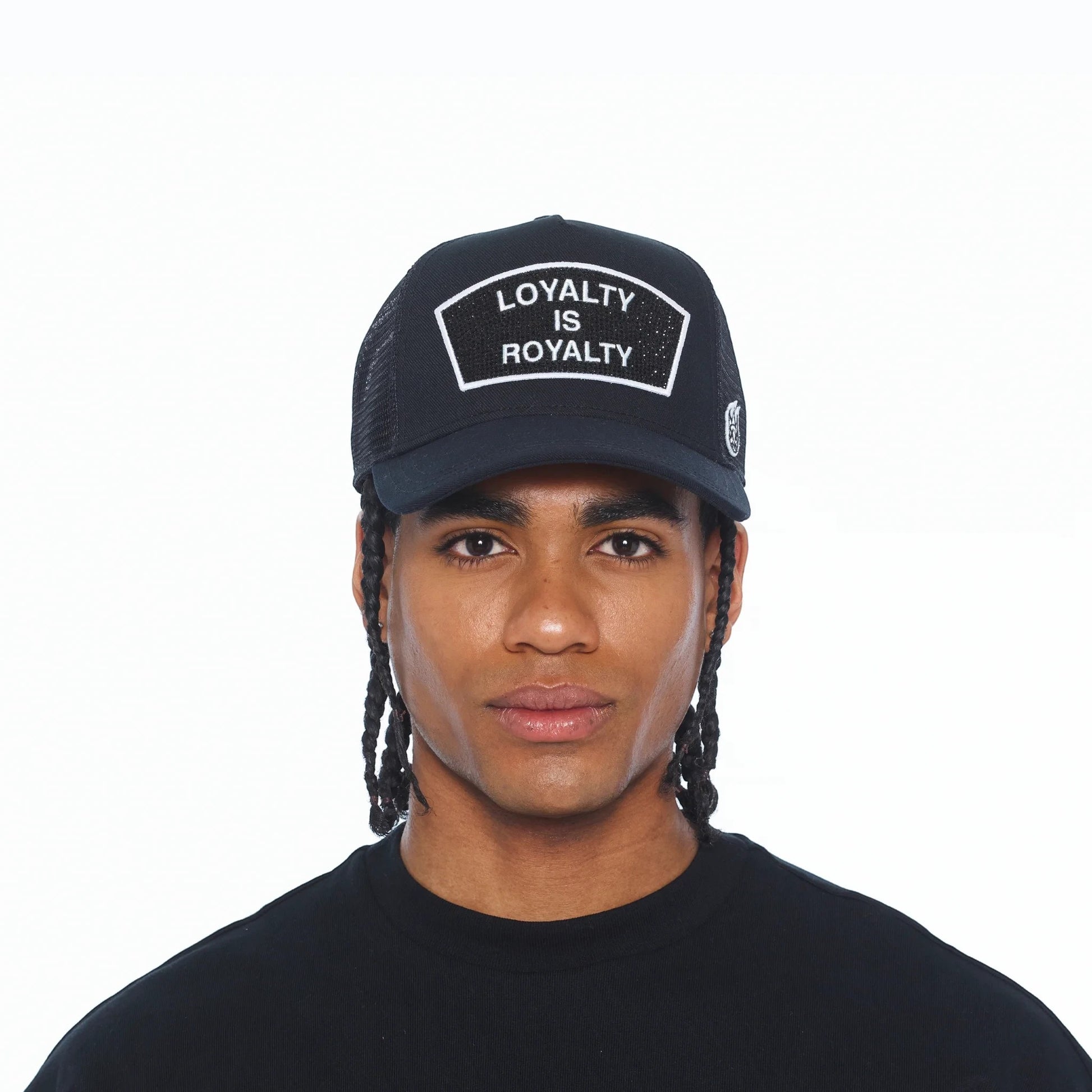 Ballers Clothing Shop black mesh trucker hat with Loyalty Is Royalty crystal patch worn by a man