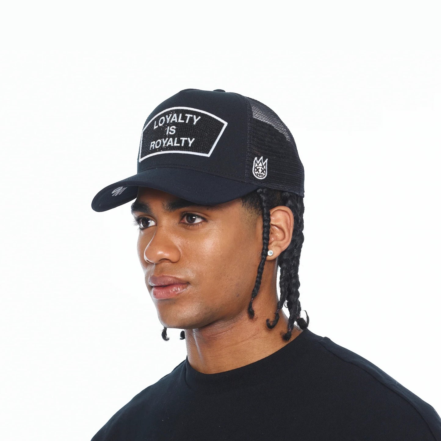 Ballers Clothing Shop black mesh back trucker hat with Loyalty Is Royalty crystal patch on a male model