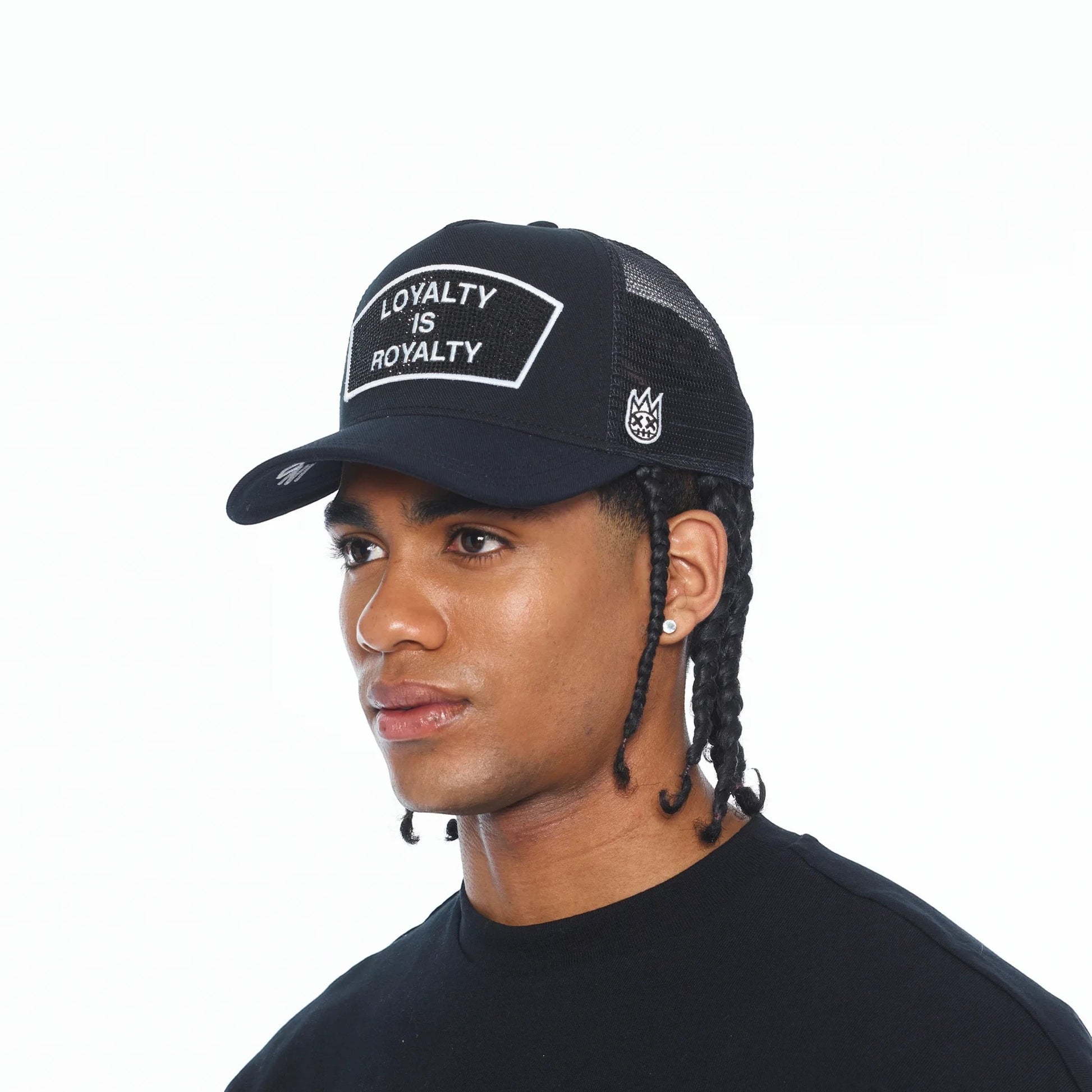 Ballers Clothing Shop black mesh back trucker hat with Loyalty Is Royalty crystal patch on a male model
