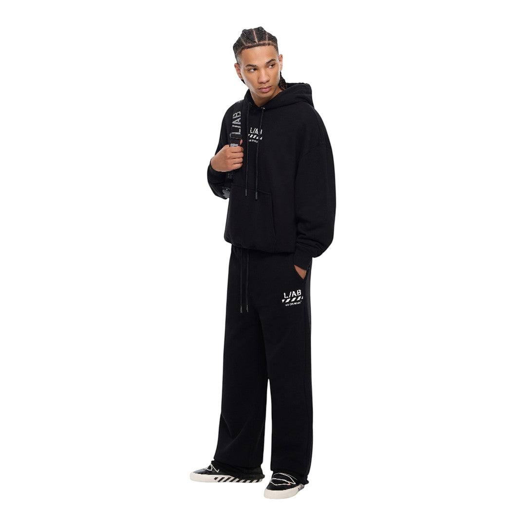 Ballers Clothing Shop model wearing black Off-White L/AB DIAG jogger pants and matching hoodie with white logo print.