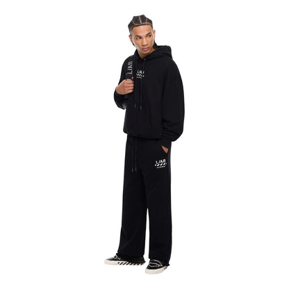 Ballers Clothing Shop model wearing black Off-White L/AB DIAG jogger pants and matching hoodie with white logo print.