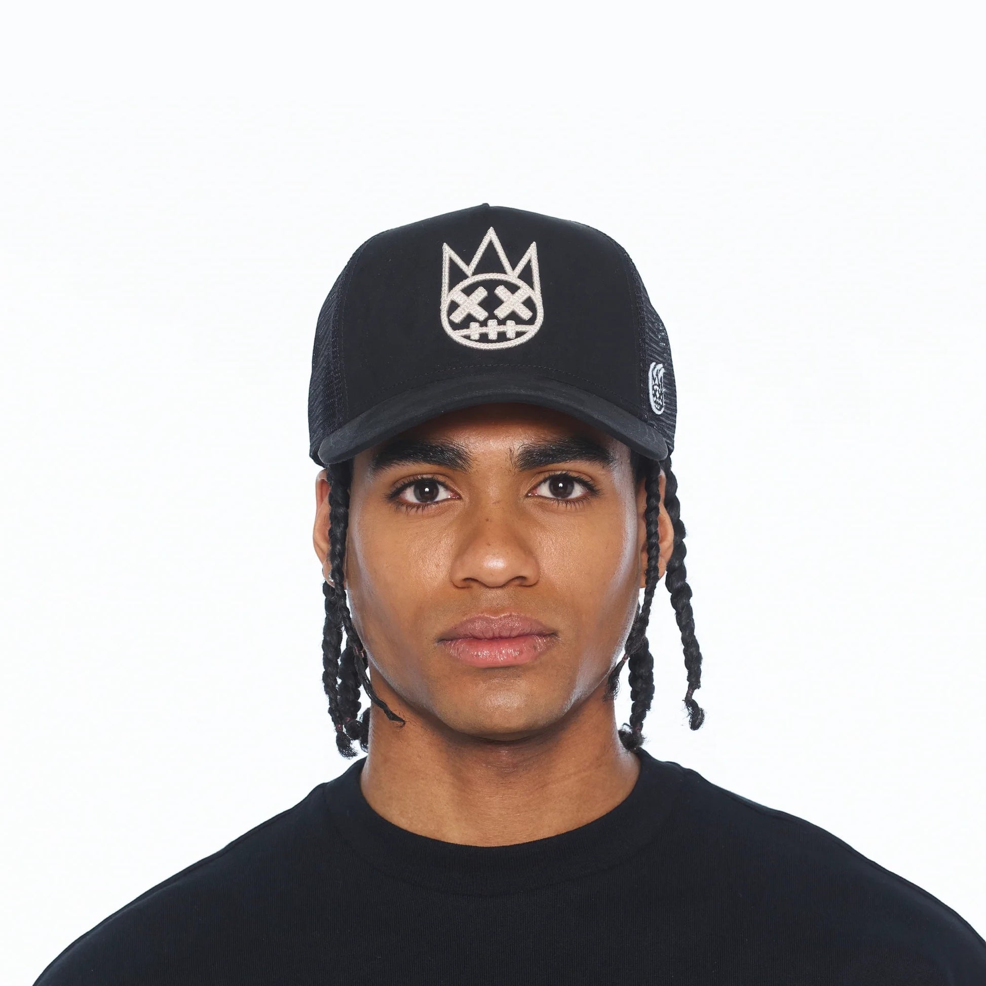 Ballers Clothing Shop black suede trucker hat with mesh back and raised white chain-stitch logo on a male model
