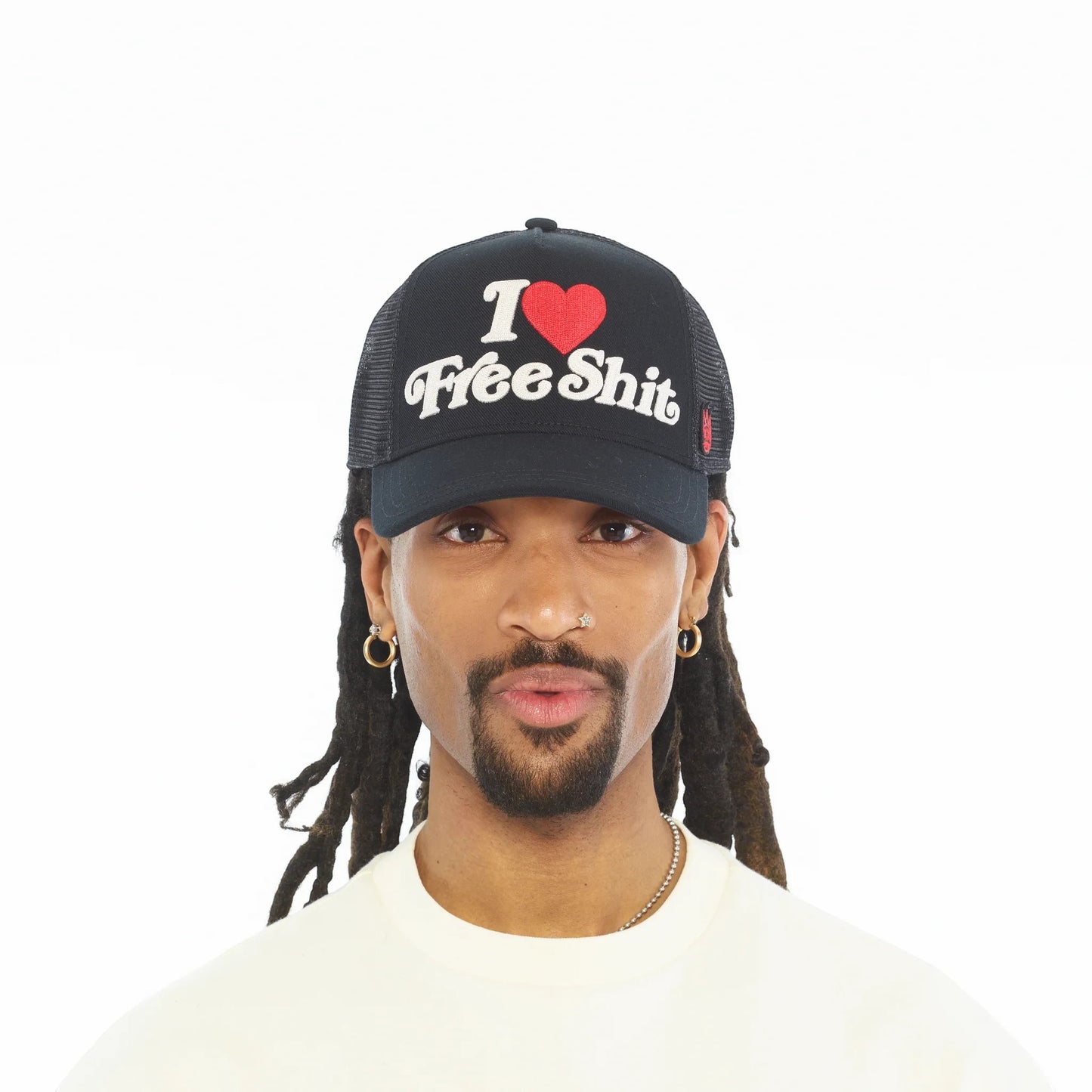 Ballers Clothing Shop black mesh back trucker hat with I Love Free Shit chainstitch embroidery worn by a man