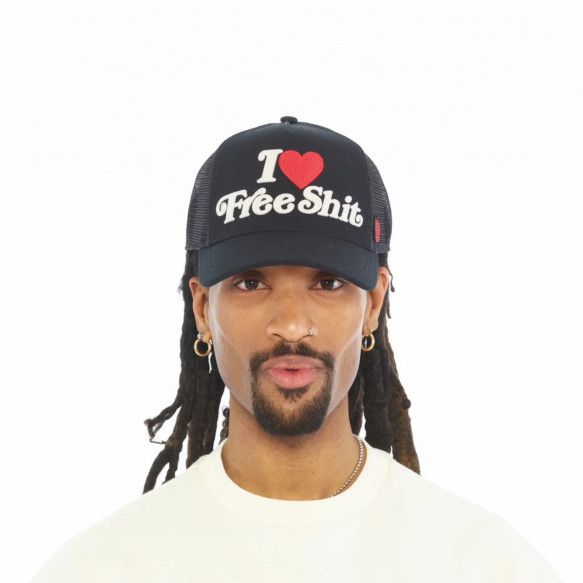 Ballers Clothing Shop black mesh back trucker hat with I Love Free Shit chainstitch embroidery worn by a man