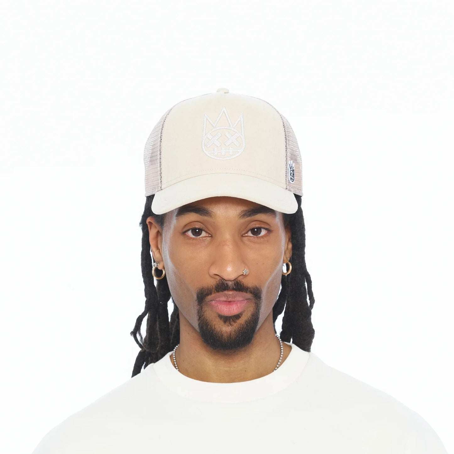 Ballers Clothing Shop cream suede trucker hat with mesh back and raised chain-stitch logo worn by a man