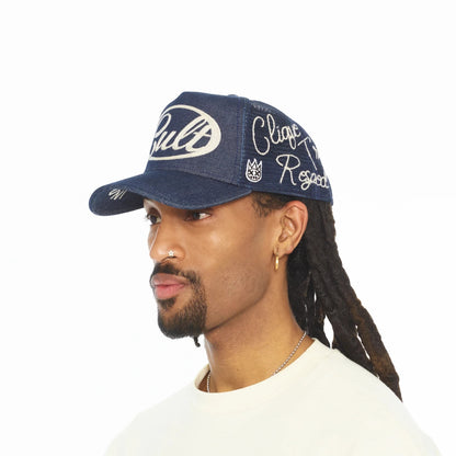 Ballers Clothing Shop denim mesh back trucker hat with white embroidered lettering and crown logo on a model