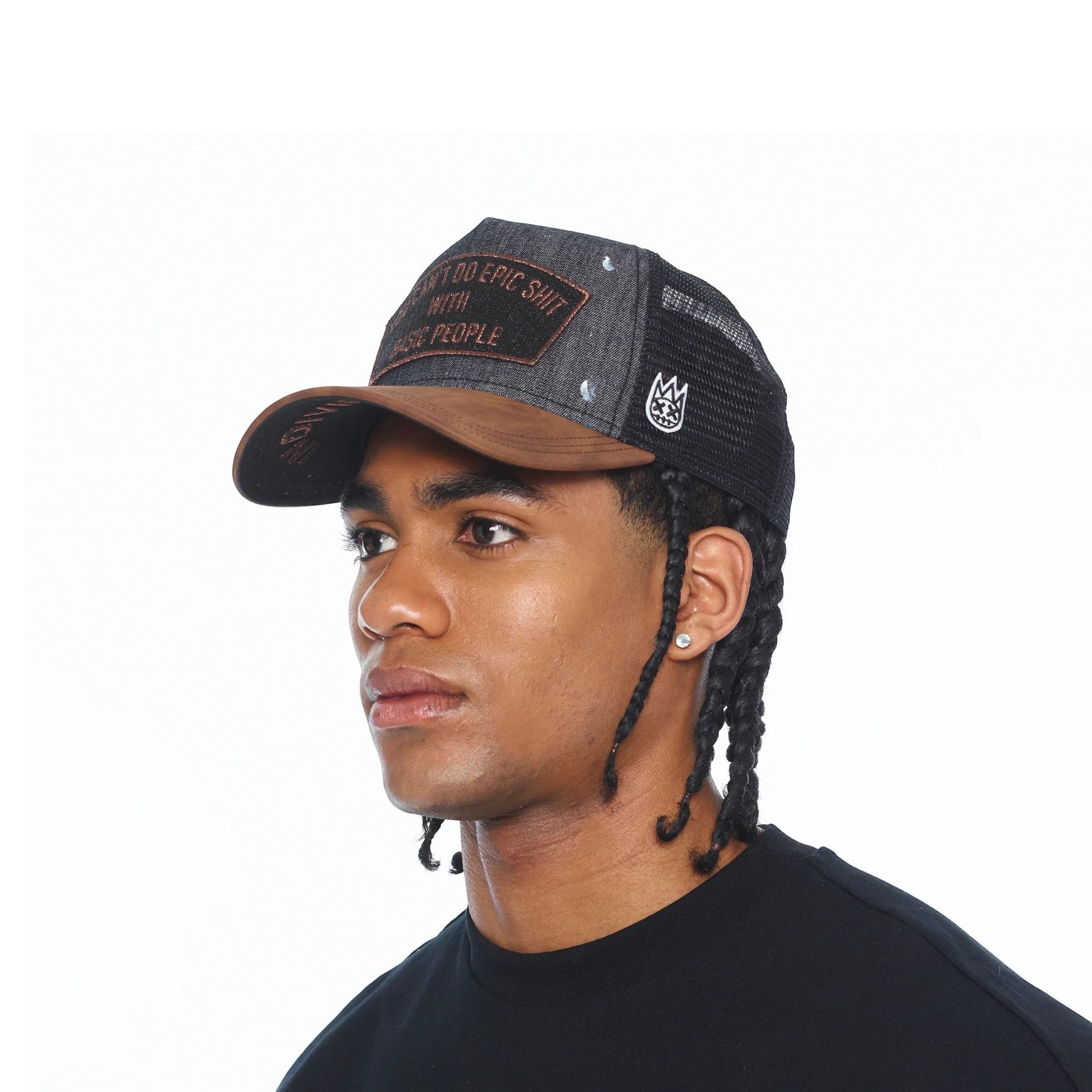 Ballers Clothing Shop black distressed denim trucker hat with mesh back and embroidered patch on a male model