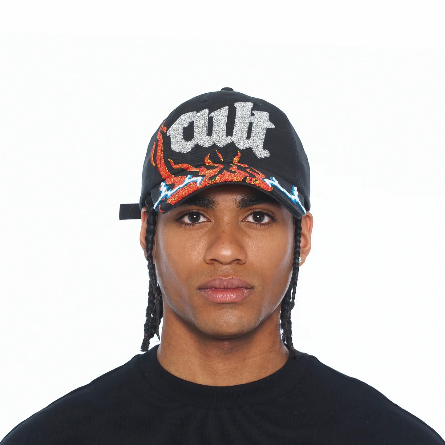 Ballers Clothing Shop black trucker hat with glittery CULT text and flame graphic on the brim worn by a man