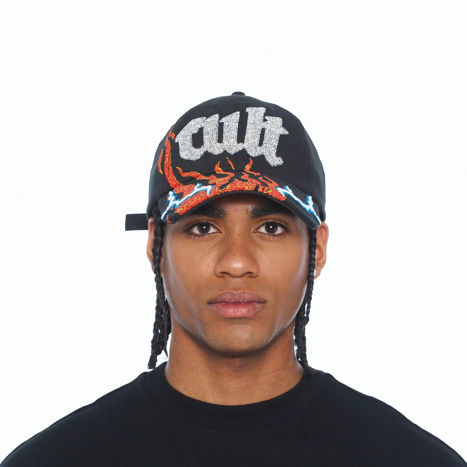 Ballers Clothing Shop black trucker hat with glittery CULT text and flame graphic on the brim worn by a man