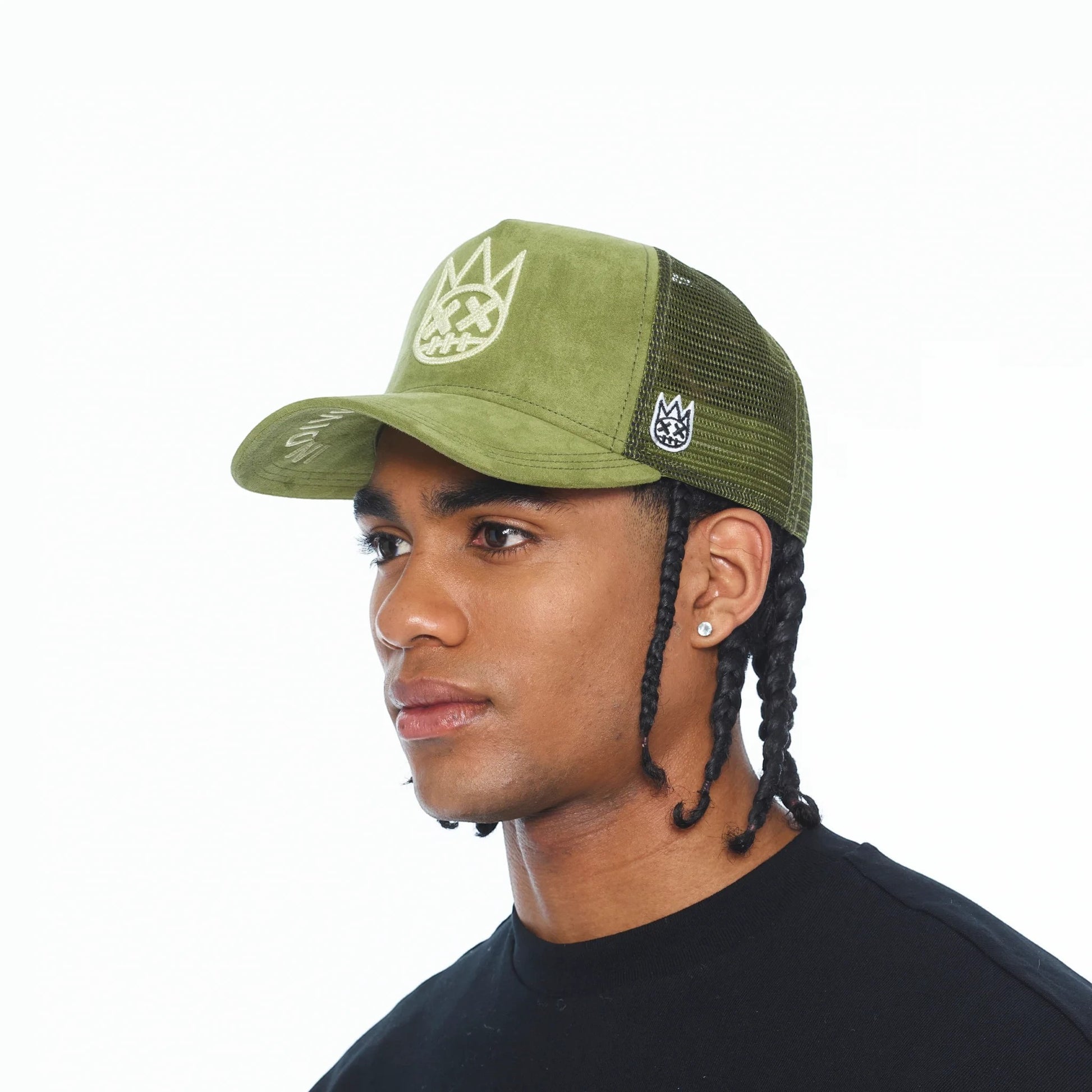 Ballers Clothing Shop sphagnum green suede trucker hat with mesh back and chain-stitch logo worn by a model.