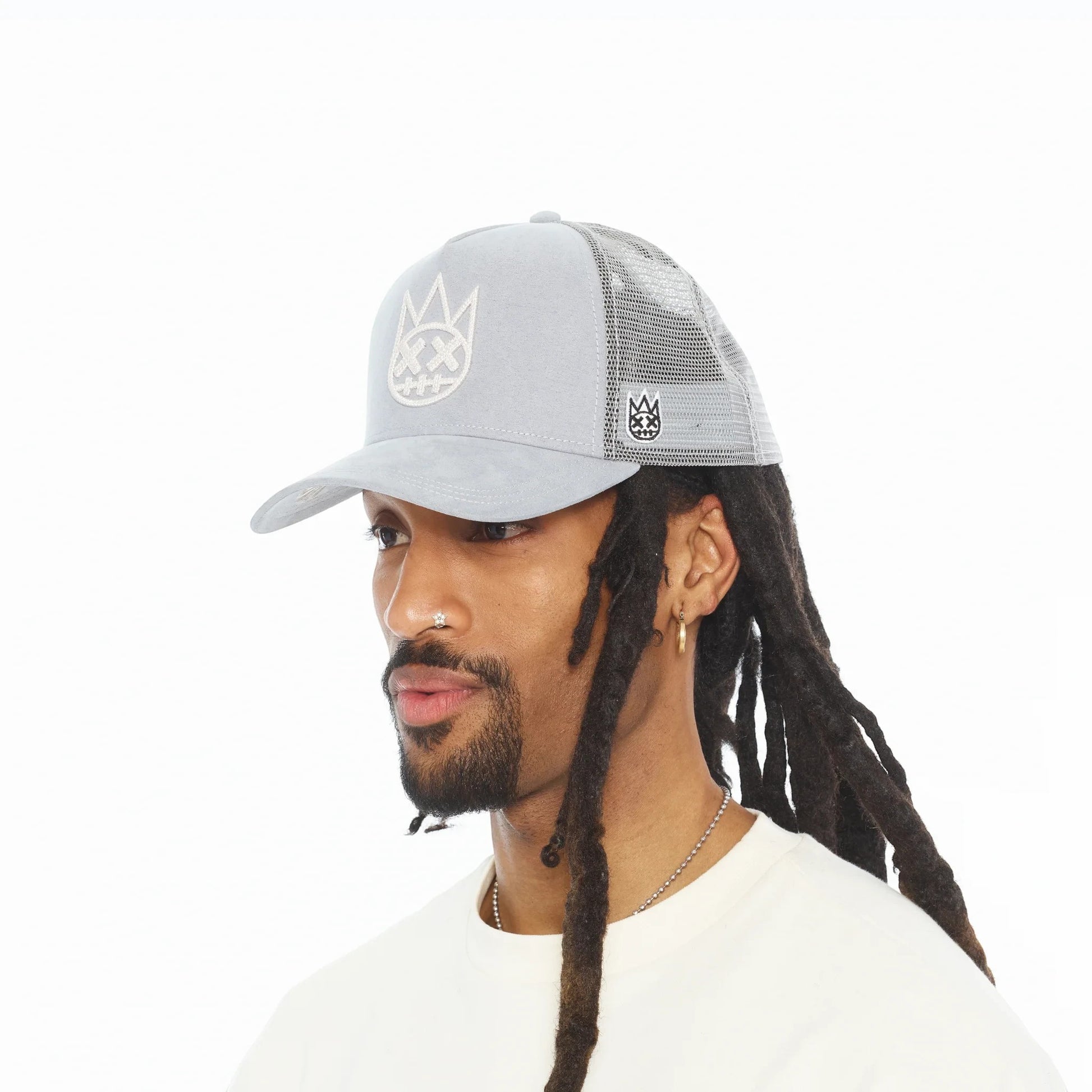 Ballers Clothing Shop grey suede trucker hat with mesh back and raised chain-stitch Shimuchan logo on a model.