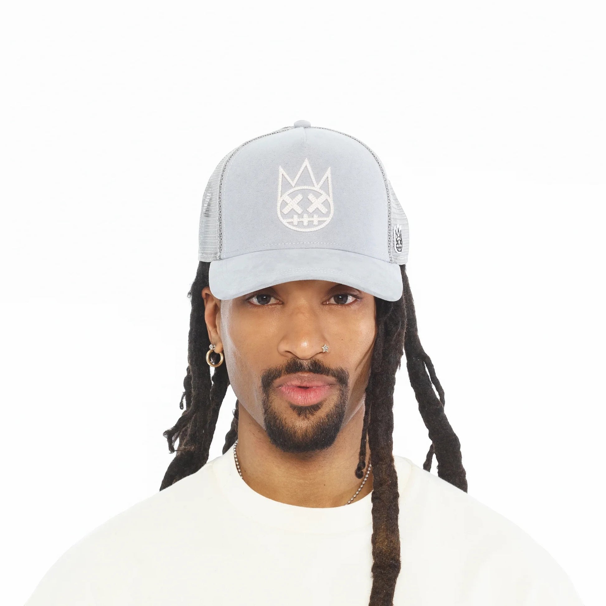 Ballers Clothing Shop grey suede trucker hat with mesh back and raised chain-stitch logo worn by a man