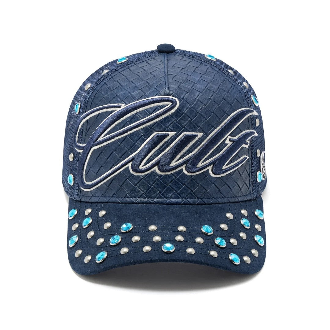 Ballers Clothing Shop navy blue trucker hat with woven texture, Cult embroidery, and silver and blue stud accents.