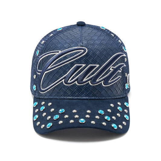 Ballers Clothing Shop navy blue trucker hat with woven texture, Cult embroidery, and silver and blue stud accents.