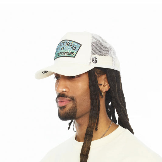 Ballers Clothing Shop white mesh back trucker hat with Pretty Good At Bad Decisions patch worn by a man with dreadlocks