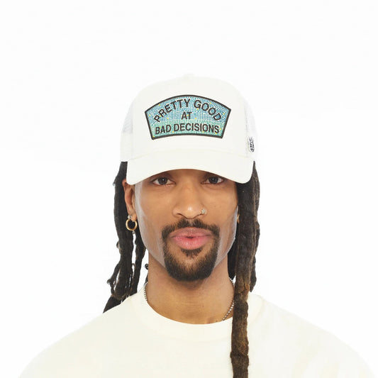 Ballers Clothing Shop white mesh back trucker hat with Pretty Good At Bad Decisions rhinestone patch on a model